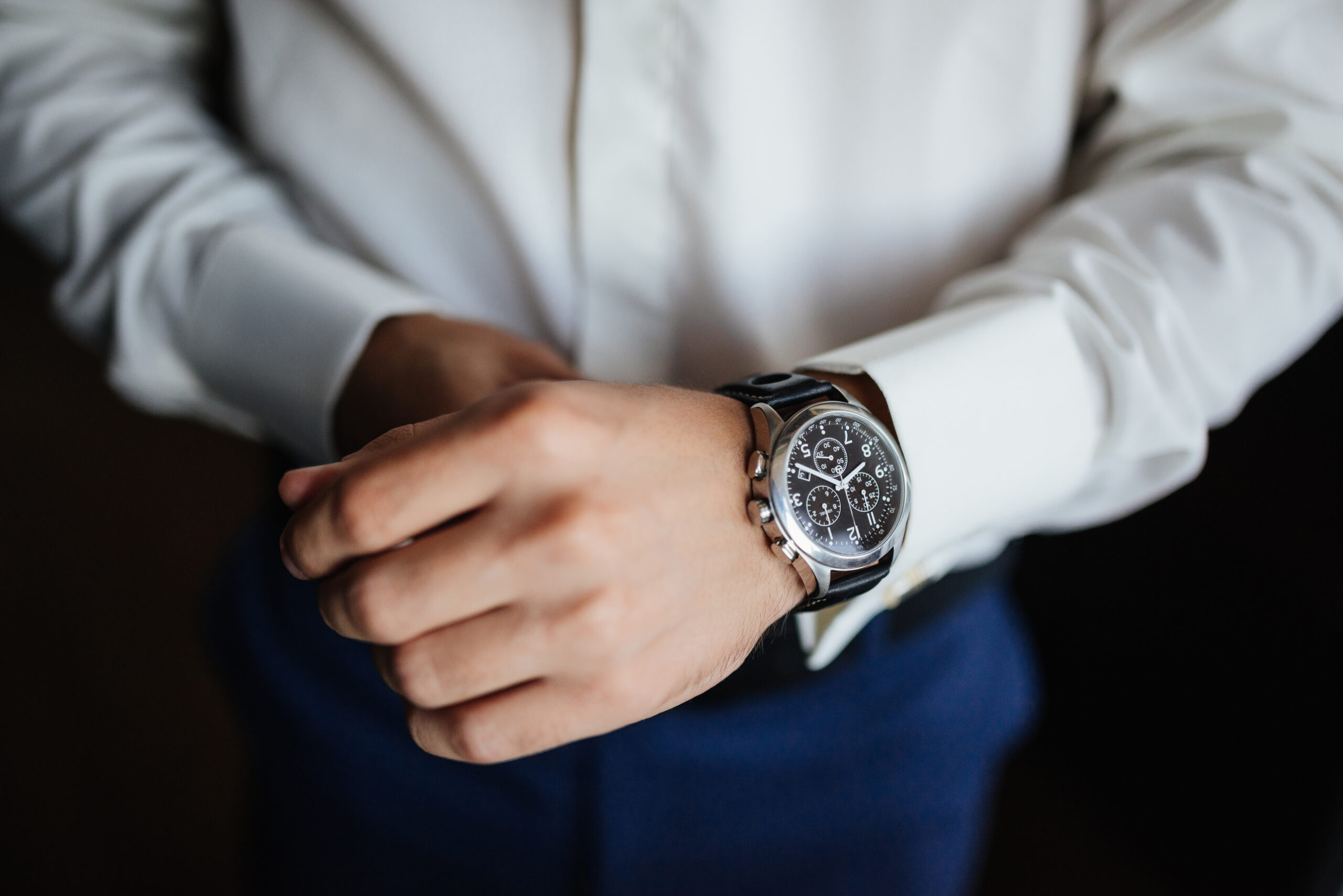 Rehearsal preparation. Groom's watches on hand. High angle view of groom, Fixing his watches before wedding.